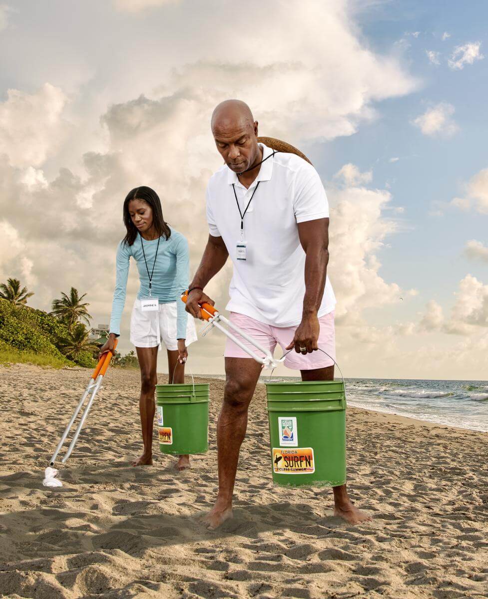 Casal limpando a praia